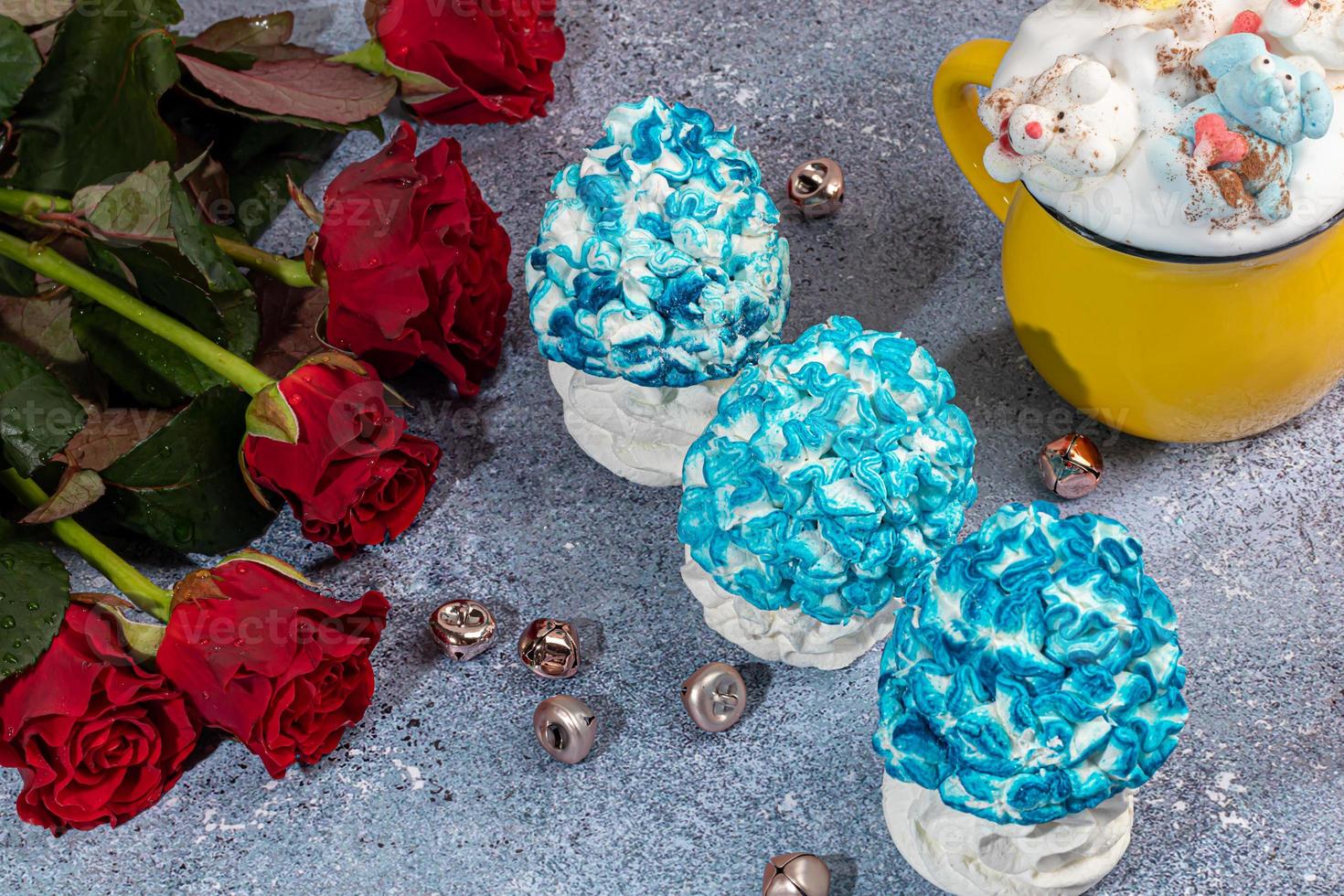 Handmade marshmallows on a light background in the form of roses, hydrangeas and tulips. There are flowers nearby. Women's day, Valentine's day. photo