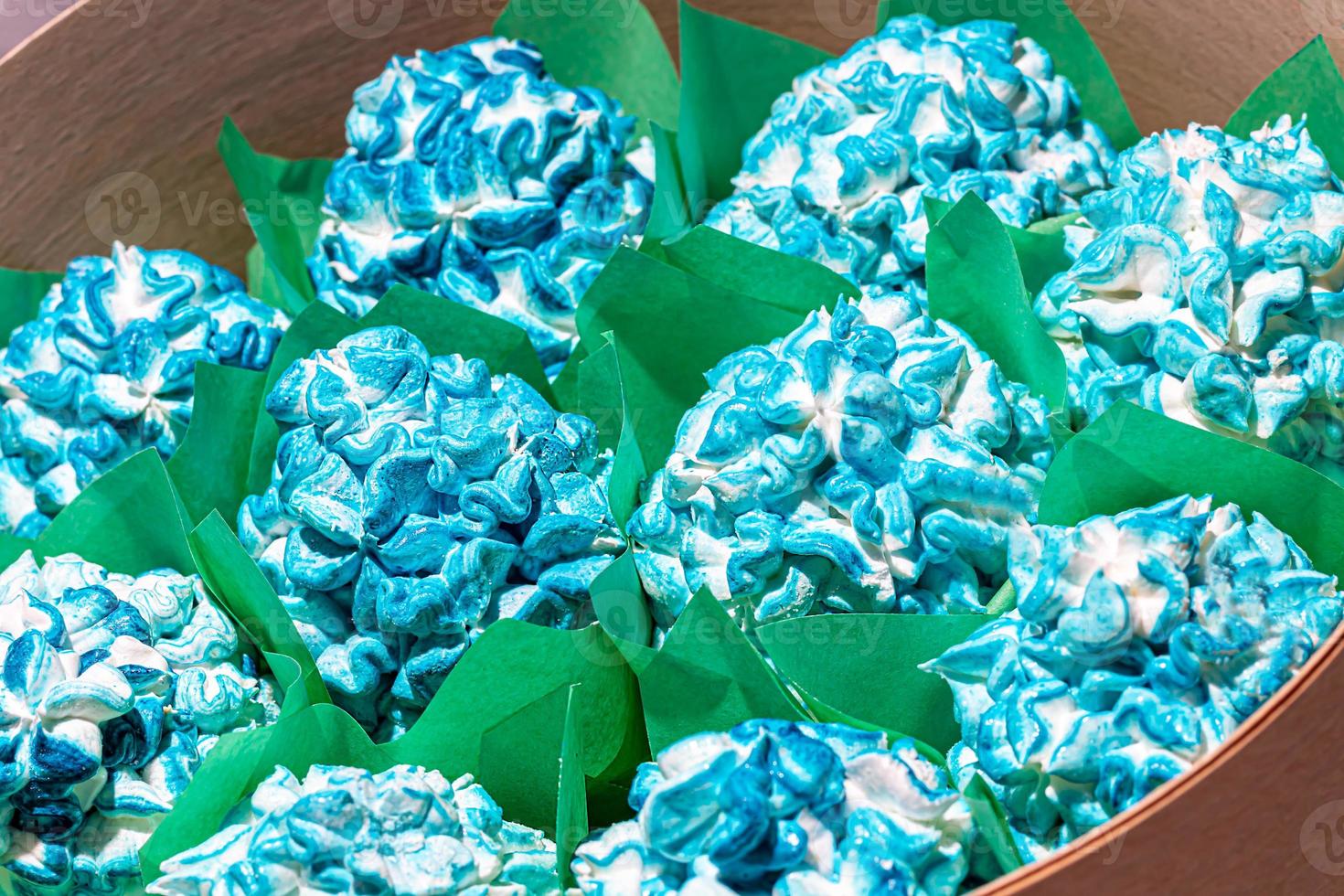 Handmade marshmallows in wooden packages on a light background with flowers. The concept of the holidays Women's Day and Valentine's Day. photo