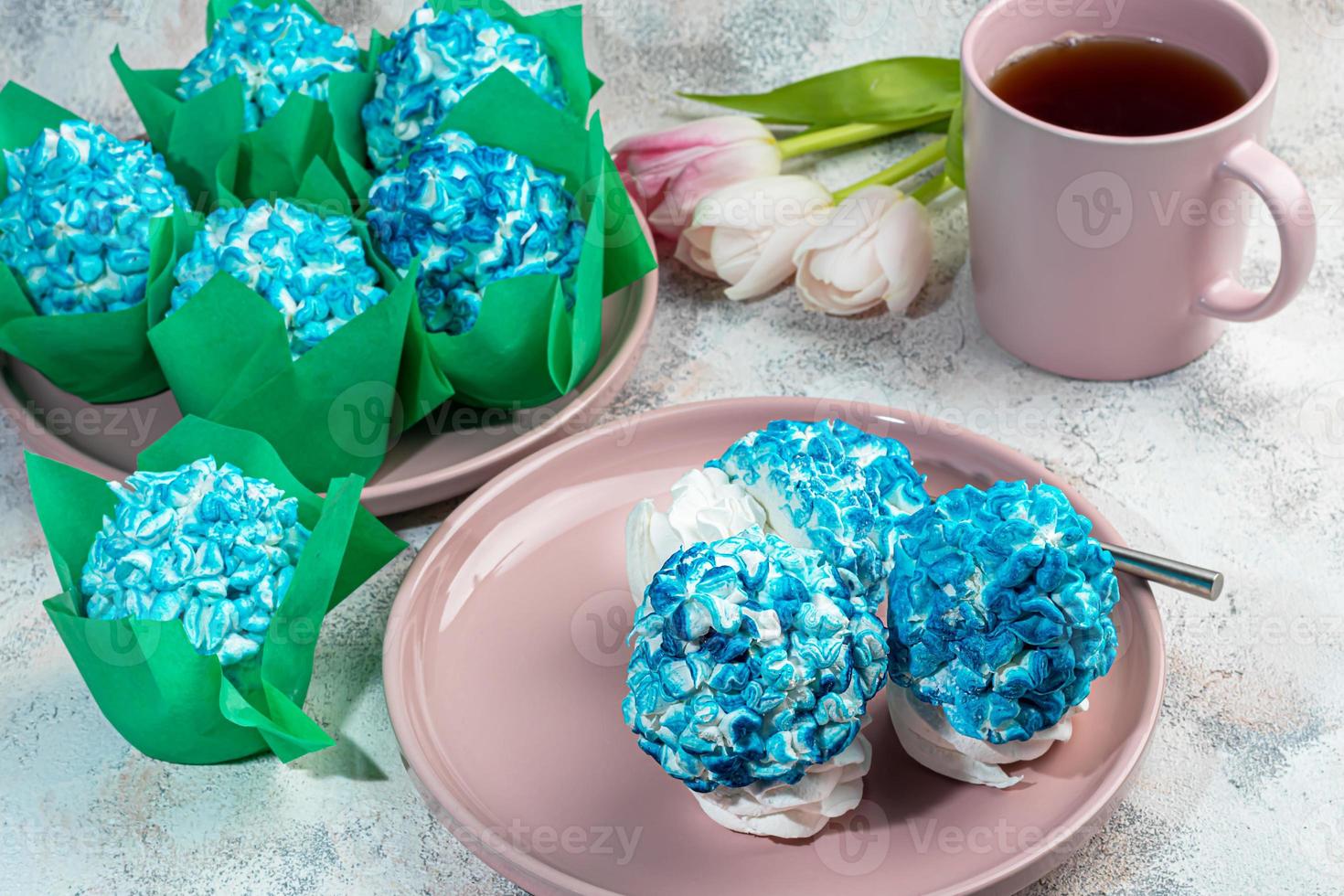 Handmade marshmallows on a light background in the form of roses, hydrangeas and tulips. There are flowers nearby. Women's day, Valentine's day. photo