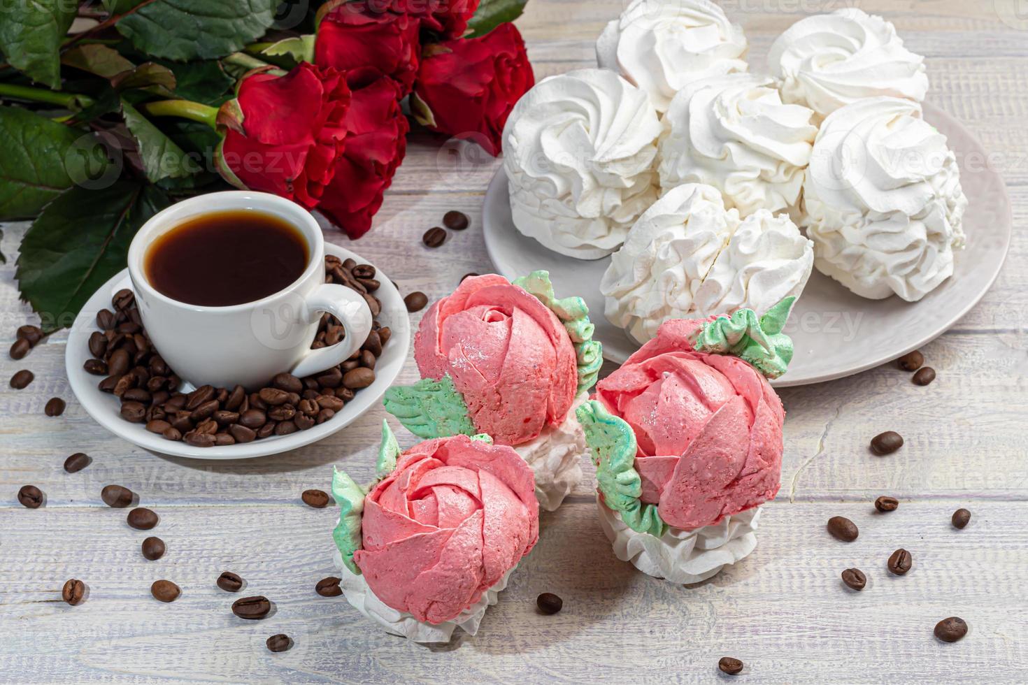 Handmade marshmallows on a light background in the form of roses, hydrangeas and tulips. There are flowers nearby. Women's day, Valentine's day. photo
