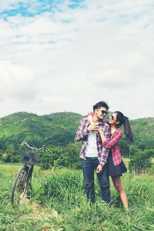 Young hipster couple holding hands walking on the meadow relaxing and natural atmosphere is very natural. photo