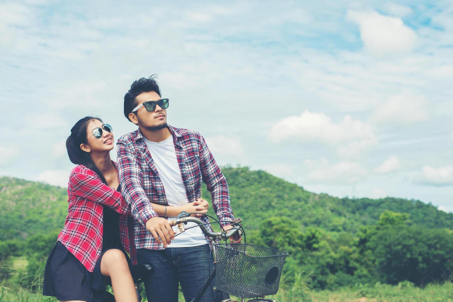 Young hipster couple holding hands walking on the meadow relaxing and natural atmosphere is very natural. photo