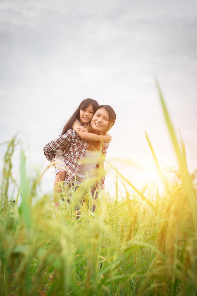 Portrait mom and daughter playing outdoor, enjoying family time. photo