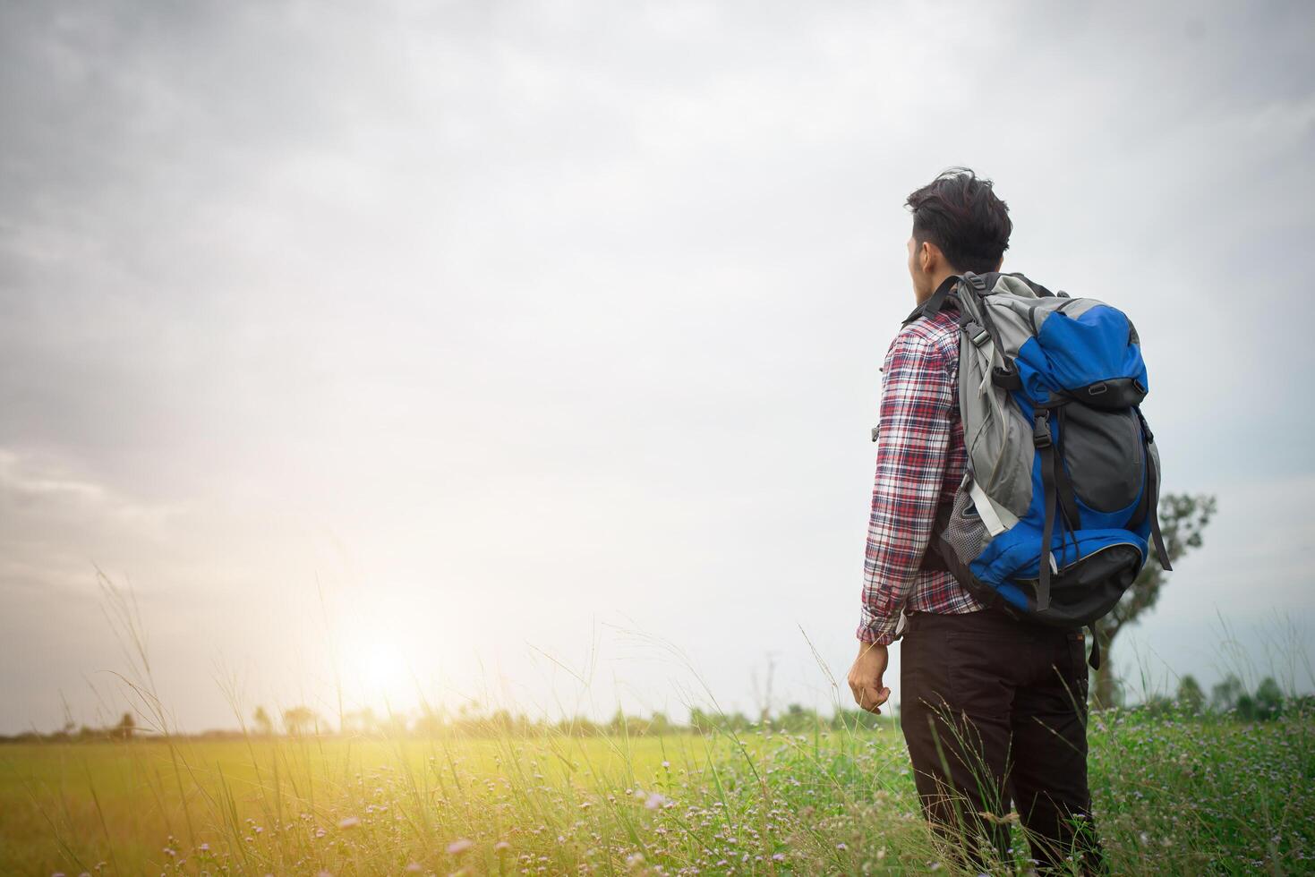 Hipster man with a backpack on his shoulders,time to go traveling,tourism concept. photo