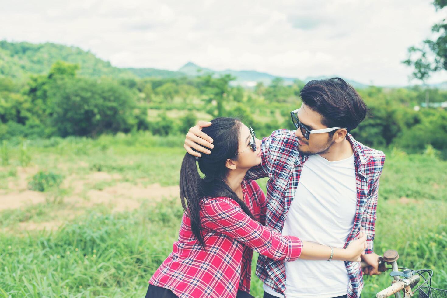 Young hipster couple holding hands walking on the meadow relaxing and natural atmosphere is very natural. photo