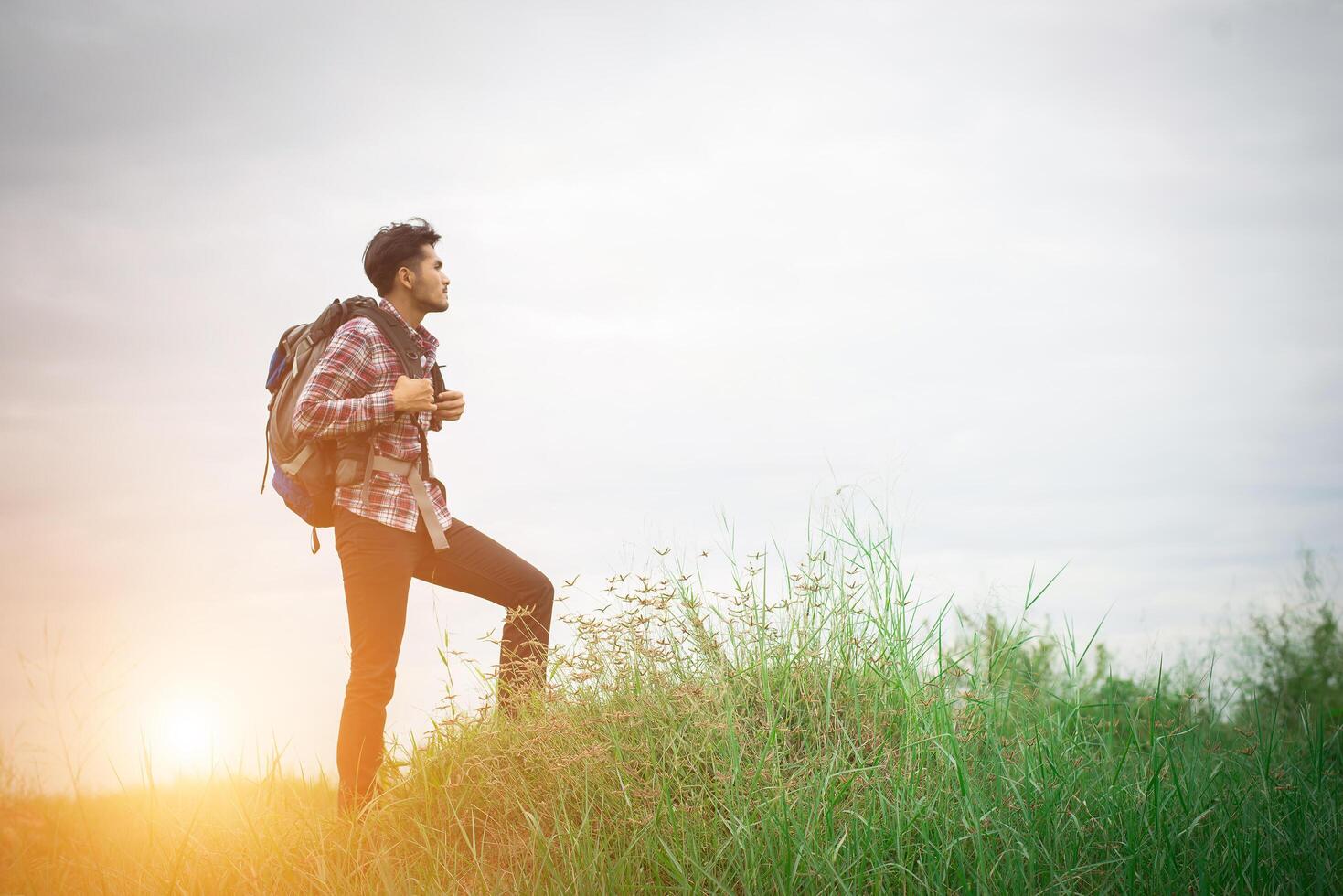 Young hipster man outdoor with backpack on his shoulder, Time to go traveling, Adventure with hiking. photo