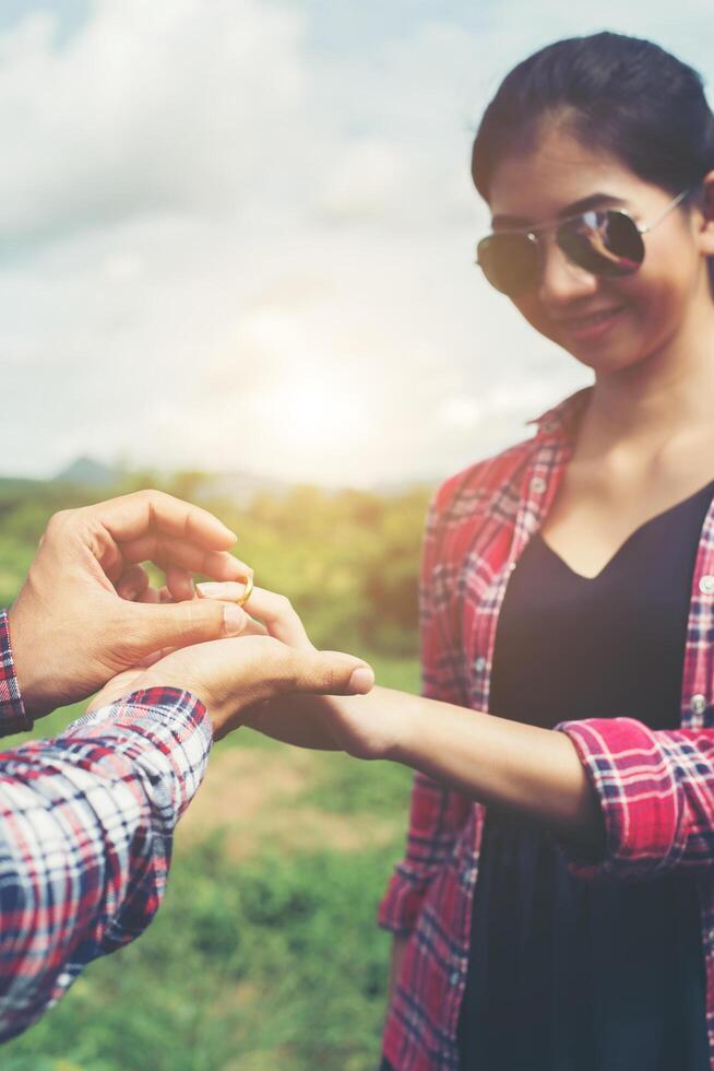 Young hipster couple wearing engagement ring in nature,Sweet and a good time in life. Happy and very grateful. photo