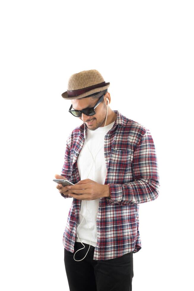 Young hipster man in earphones holding smartphone isolated on the white background. photo