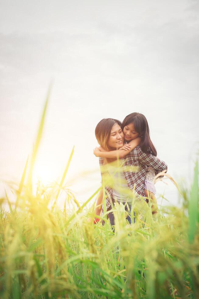 Portrait mom and daughter playing outdoor, enjoying family time. photo