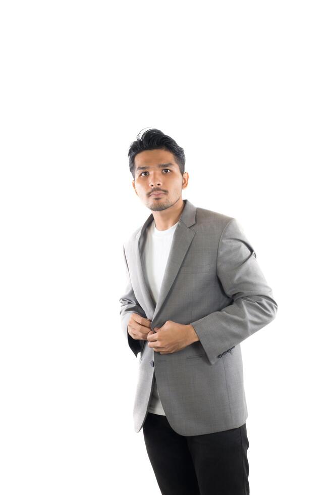 Portrait of young hipster man button up on gray suit  casual poses at studio. photo