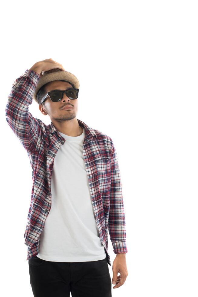 Portrait of young hipster man adjusting hat with head at camera on isolated over white studio background. photo