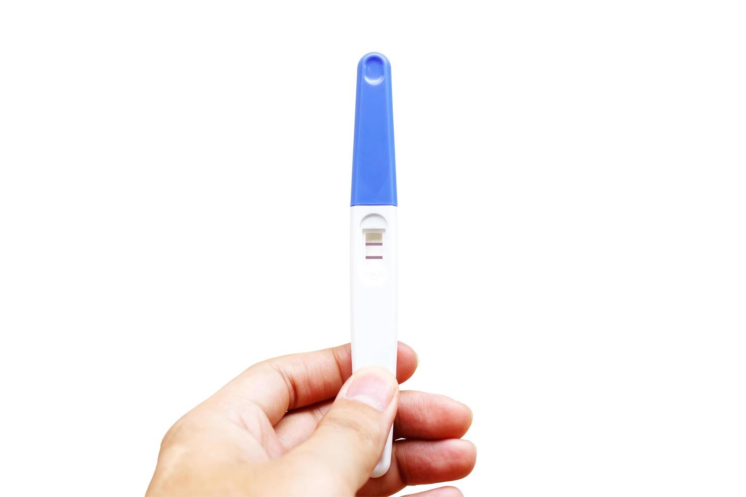 Woman is holding positive pregnancy test in her hand. Close-up. Isolated on white background.With clipping path. photo