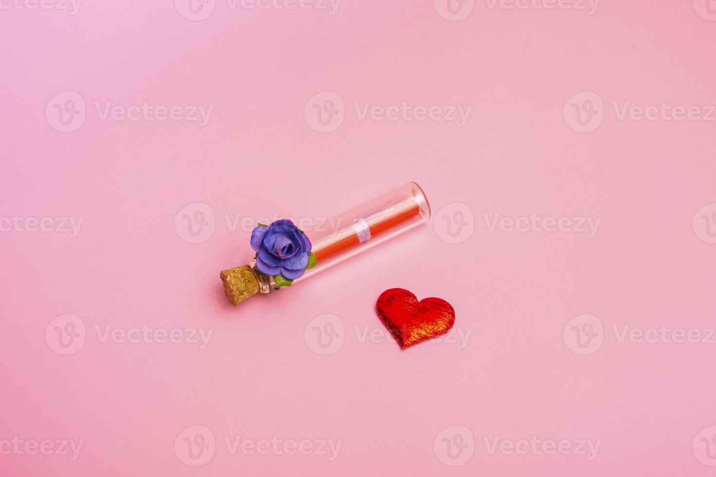 A bouquet of blue roses and a bottle with a message on a pink background. Banner for valentine's day or mother's day copy space. photo