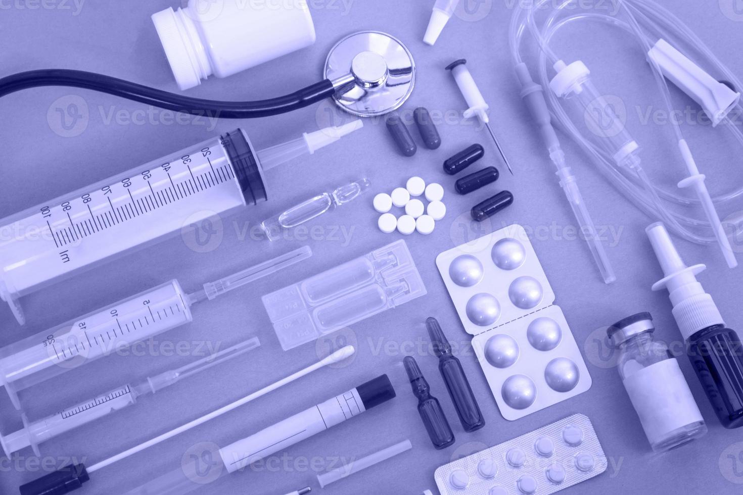 Flat lay of various medical supplies on blue background, copy space photo