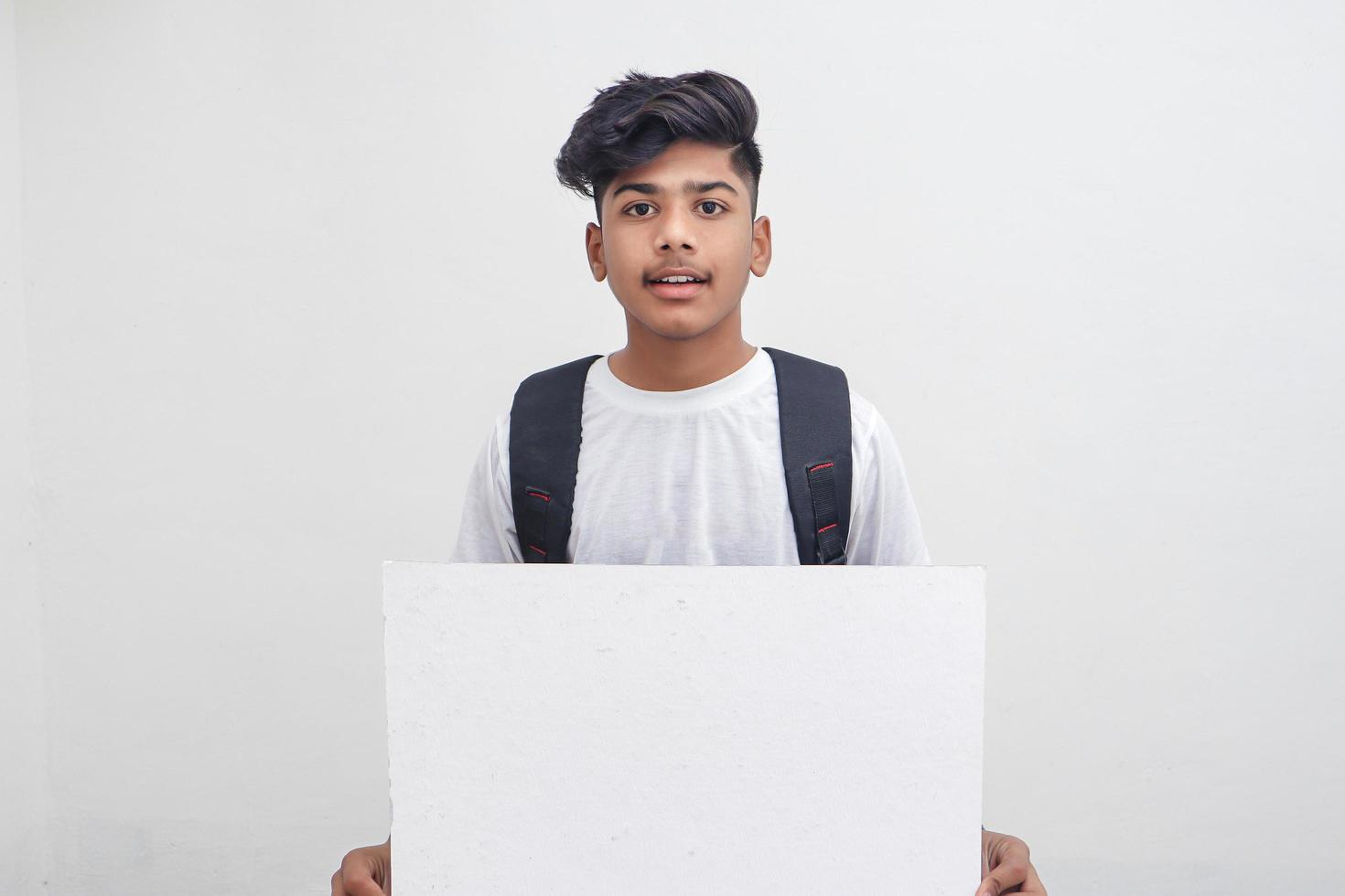 Indian college student showing board on white background. photo