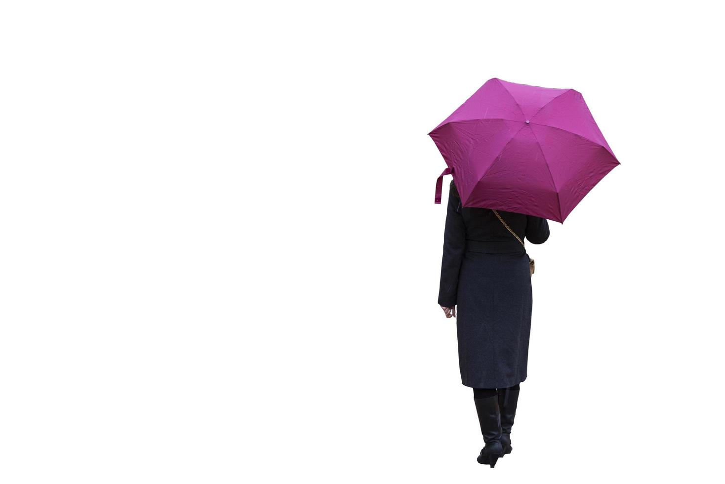 A girl with an umbrella on a white background is standing with her back. photo