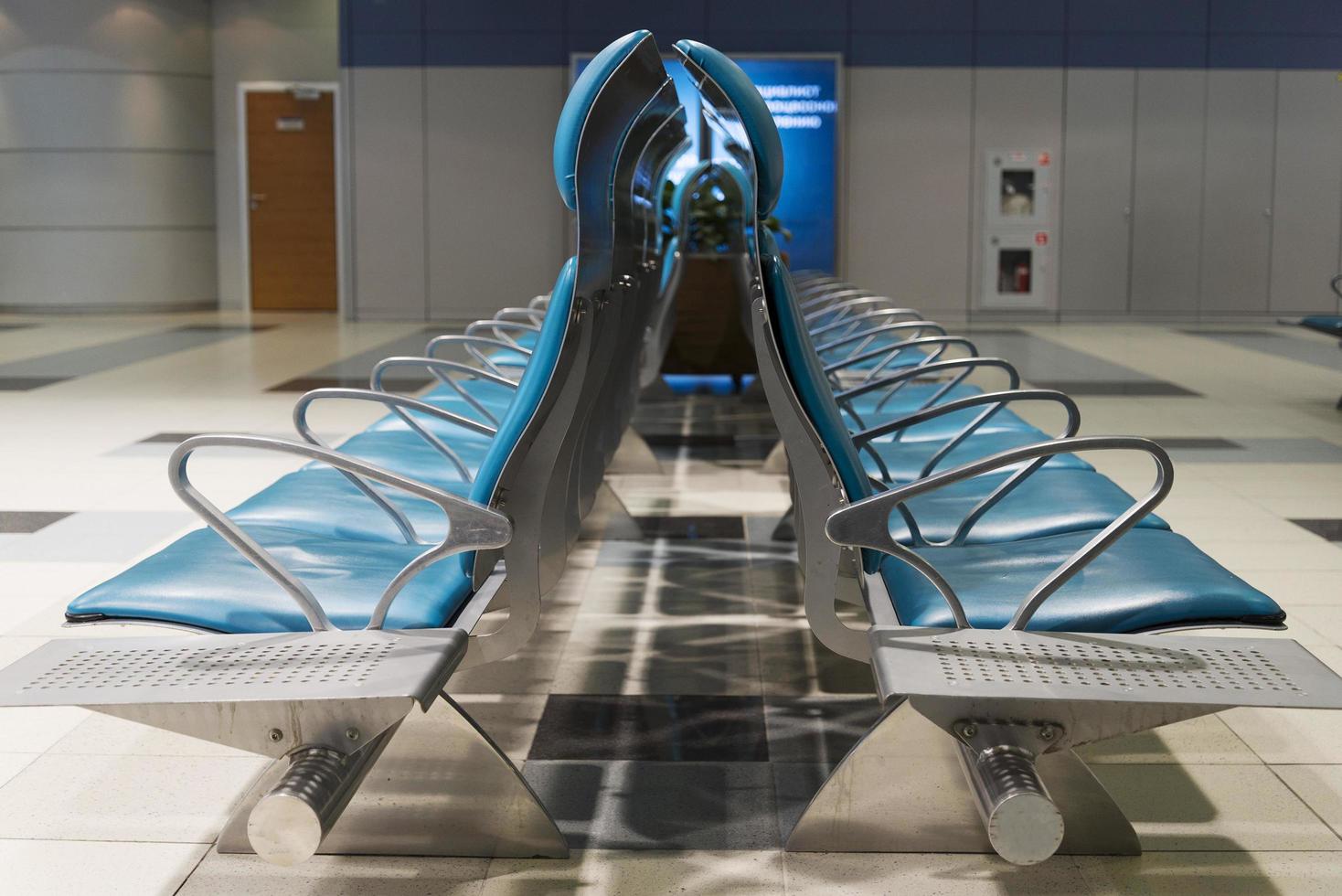 Seats without people in airport waiting building. photo