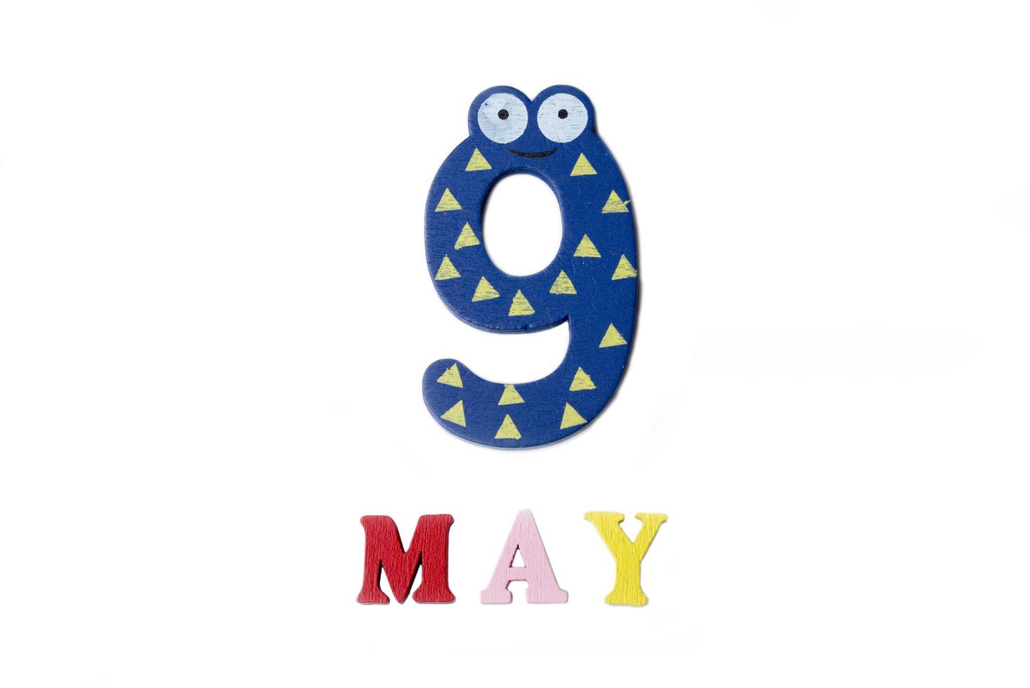 Number nine and the word may on a white background. photo