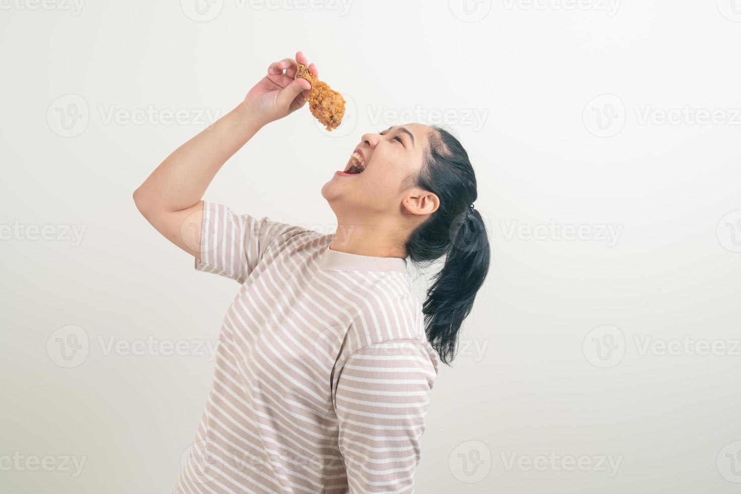 Asian woman with fried chicken on hand photo