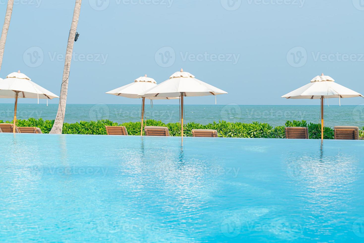 umbrella with bed pool around swimming pool with ocean sea background