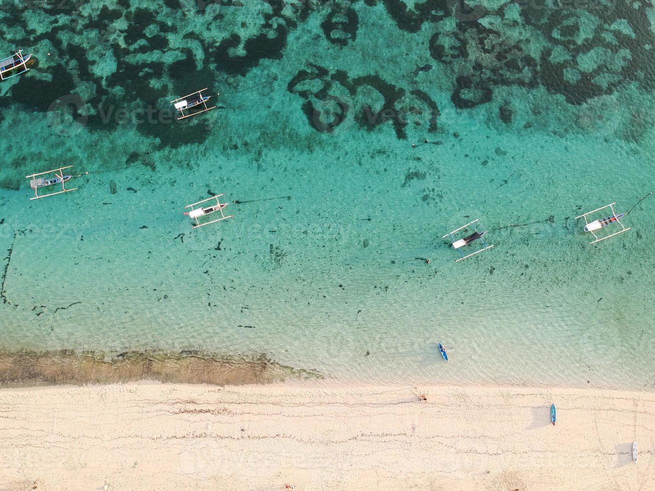 Pandawa Beach Bali Indonesia. Tourist boat leaning on the beach photo