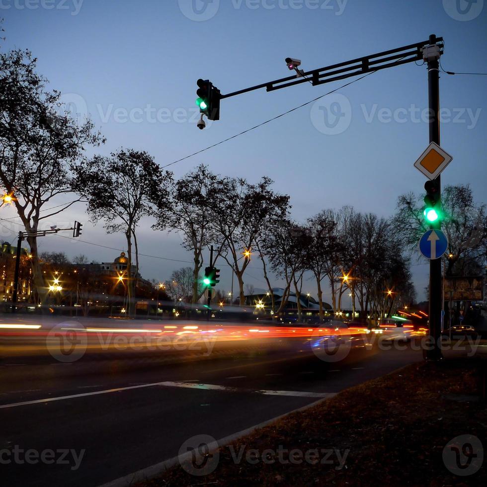 Night street view with traffic lights and light trails. photo