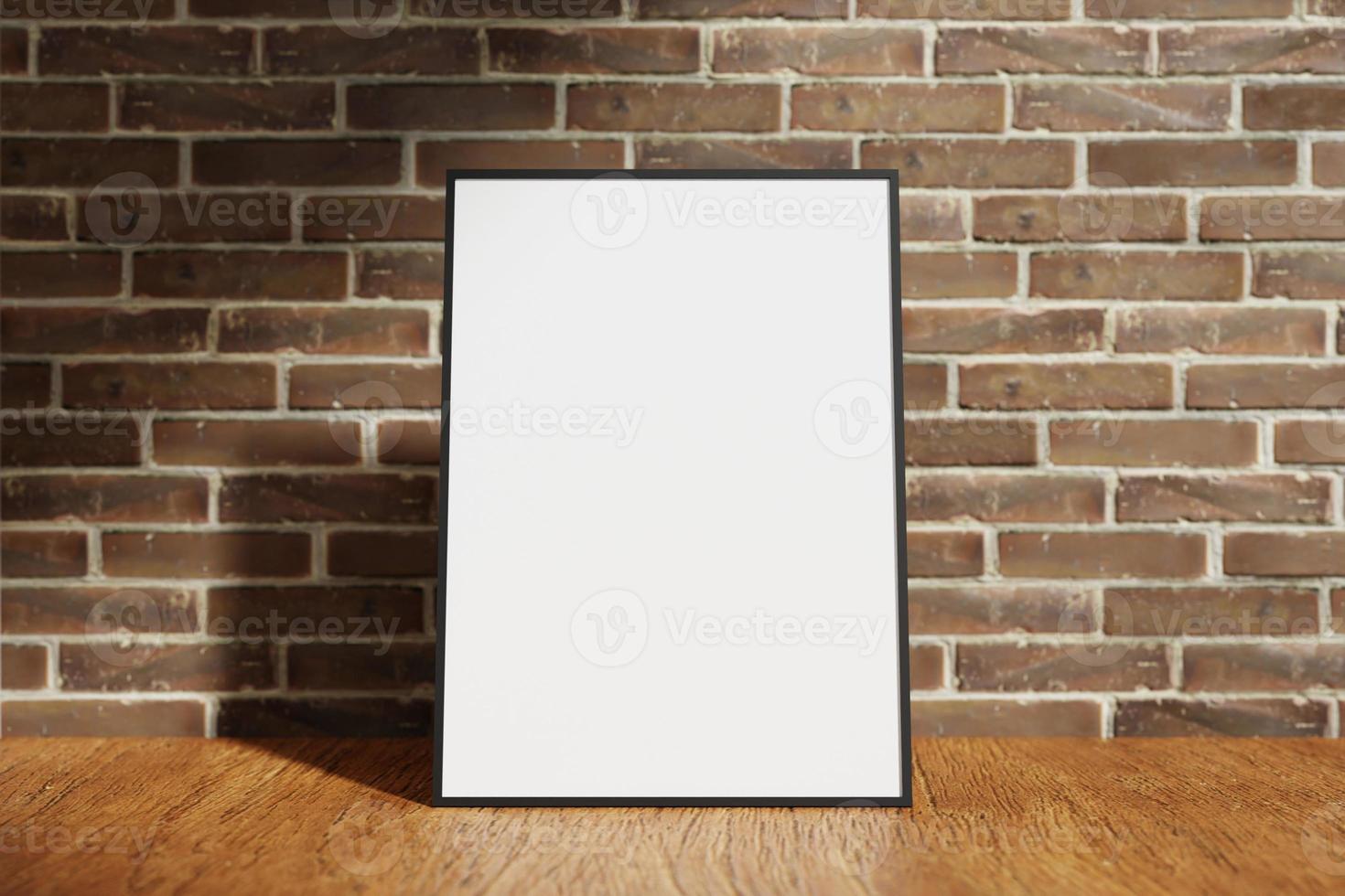 Vertical black poster or photo frame mockup on the wooden table with blurry brick background