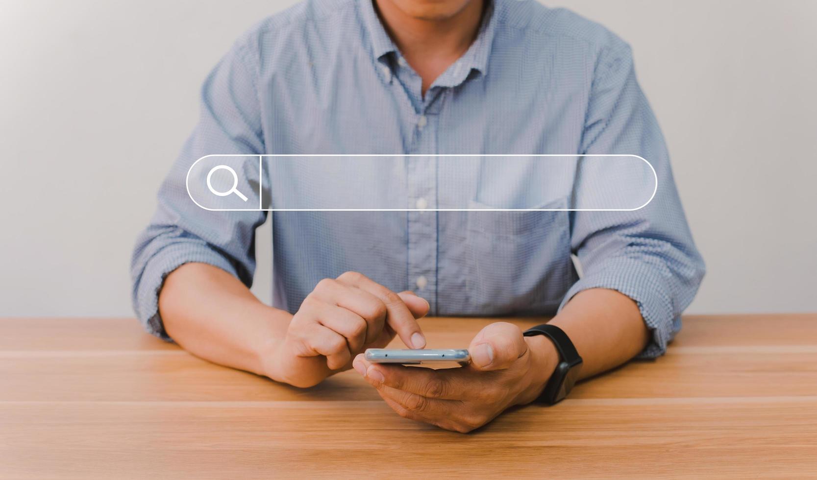 Man's hand pressing a search button photo