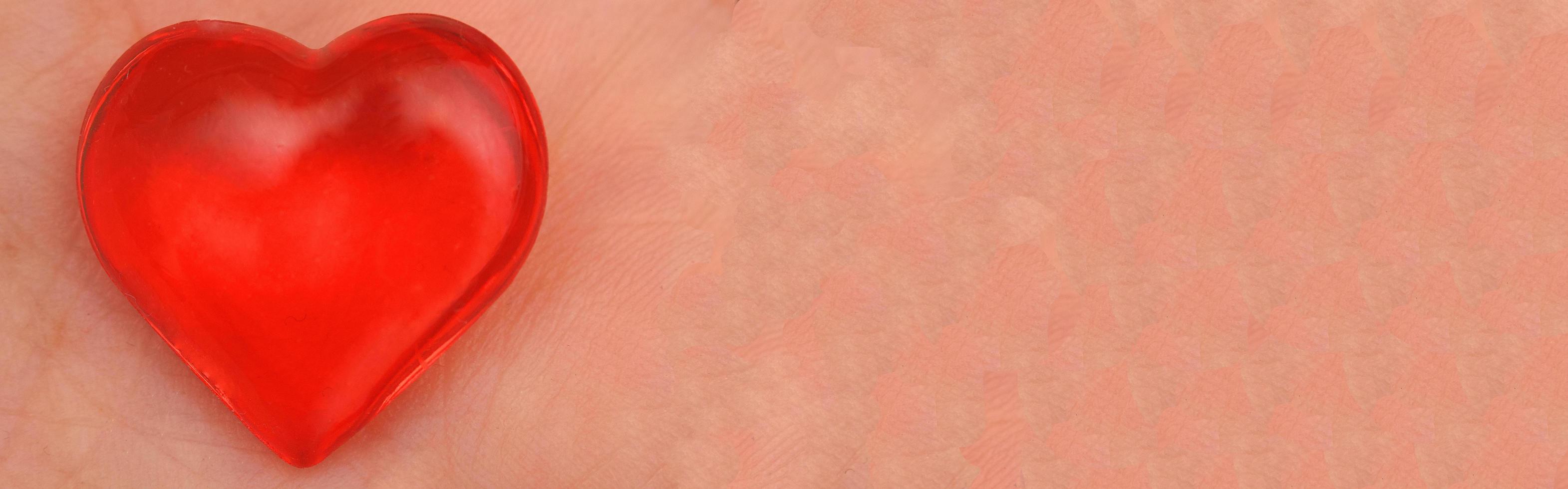 Red Valentines heart on pink skin background. photo