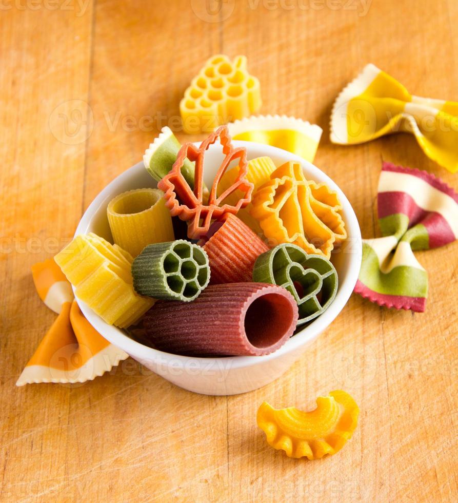 Multicolored italian pasta in bowl photo