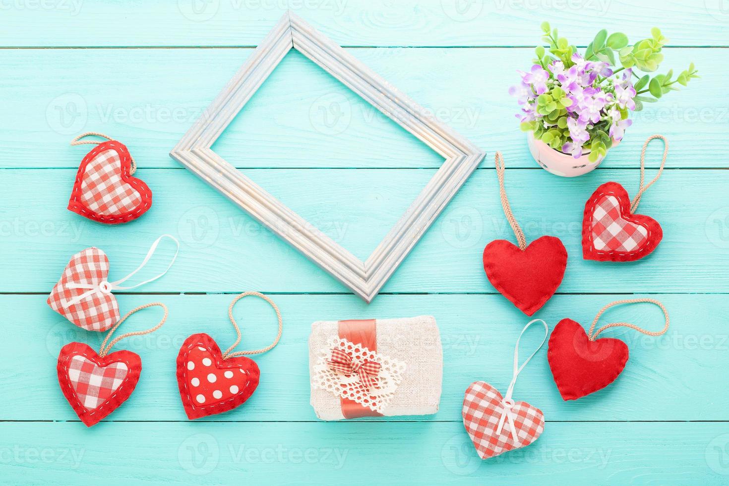 Romantic frame with copy space and accessories on blue wooden background. Top view photo