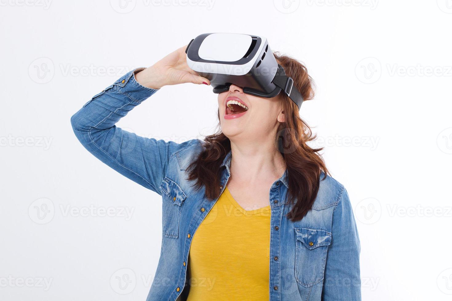 Woman wearing VR headset and looking up in virtual reality isolate on white background. Computer technology. Copy space and mock up. photo
