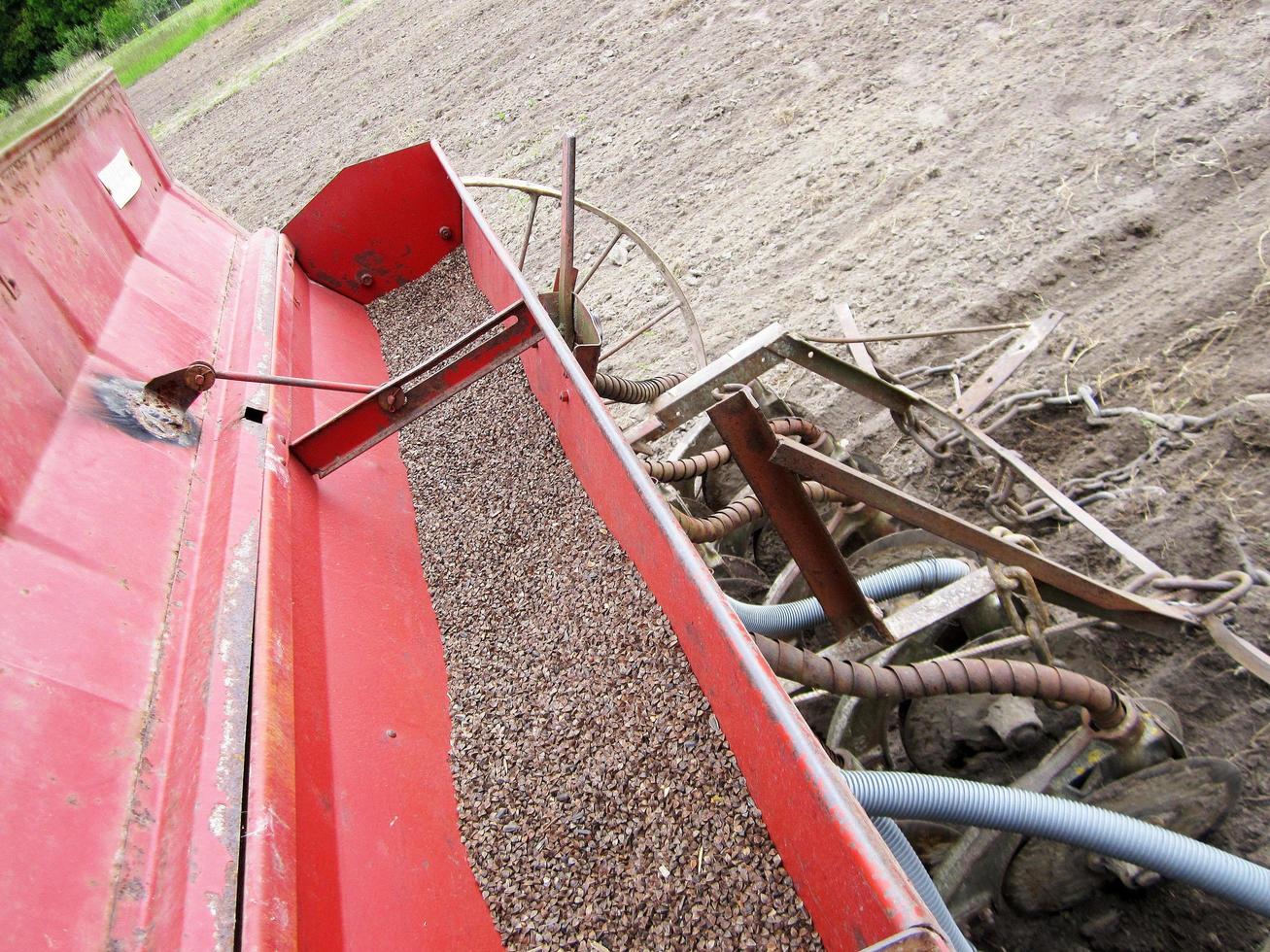 Plowed field by tractor in brown soil on open countryside nature photo