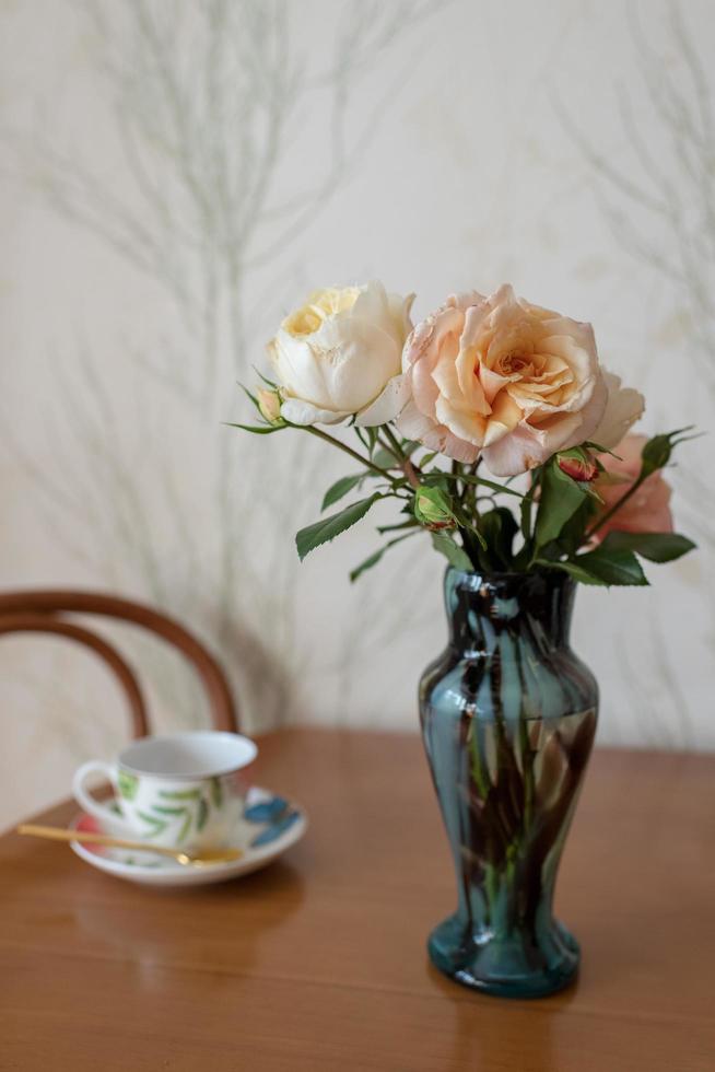 Photography to theme beautiful bouquet roses in vase on wooden table photo