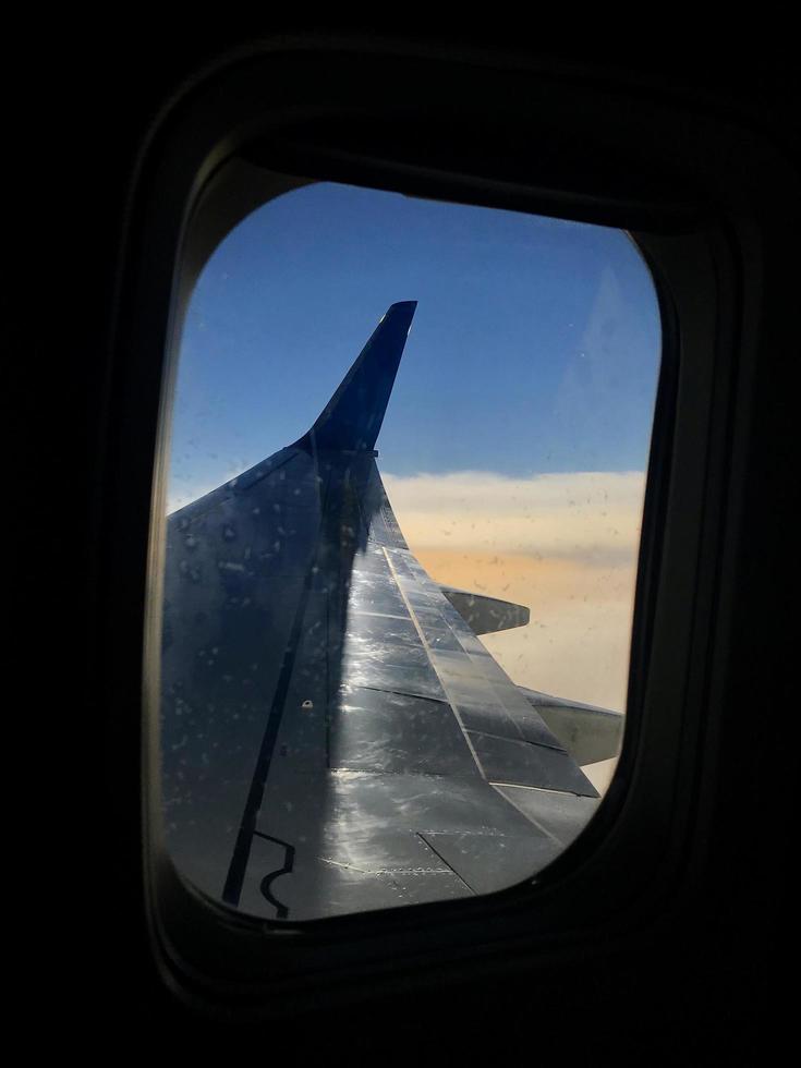 Beautiful view from airplane window, large wing of aircraft shows casement photo