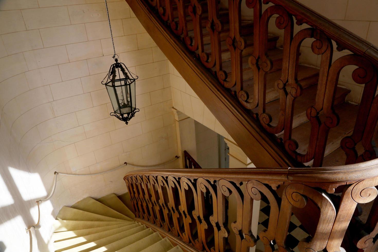 View bottom up on beautiful luxury staircase with wooden railings photo