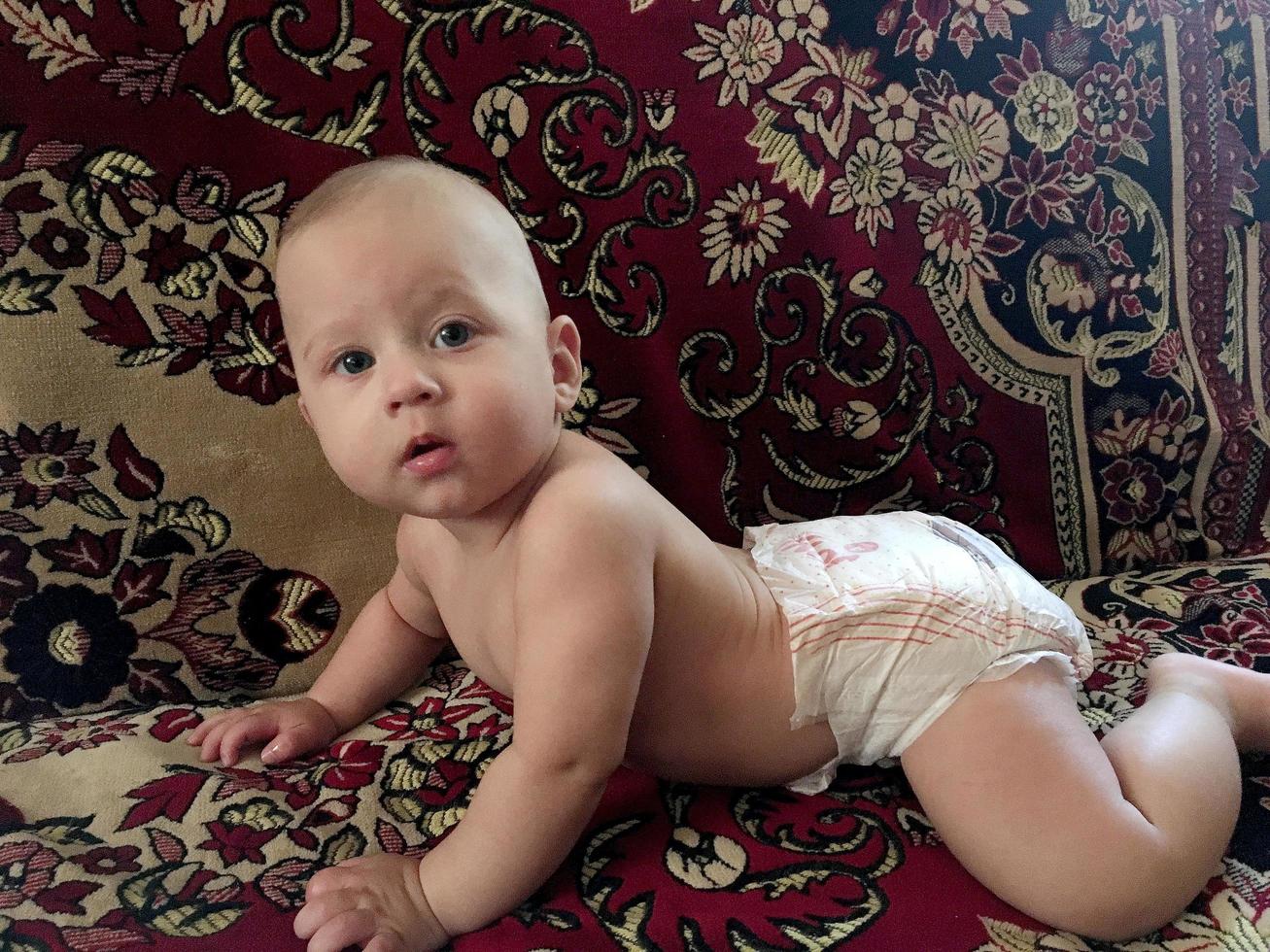 Beautiful baby boy with child face posing photographer photo