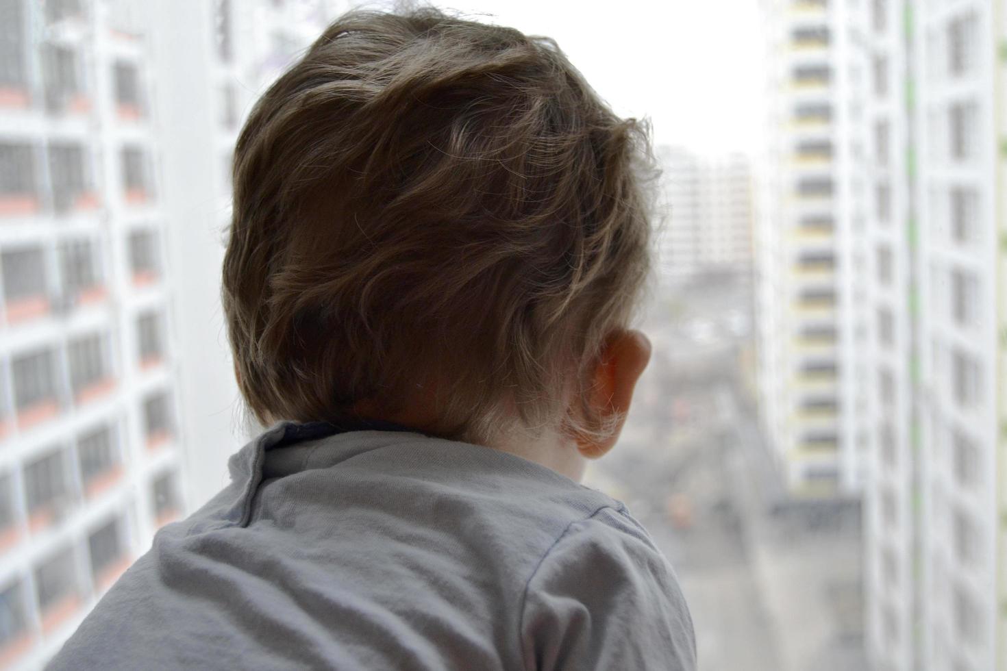 Beautiful baby boy with child face posing photographer near window photo