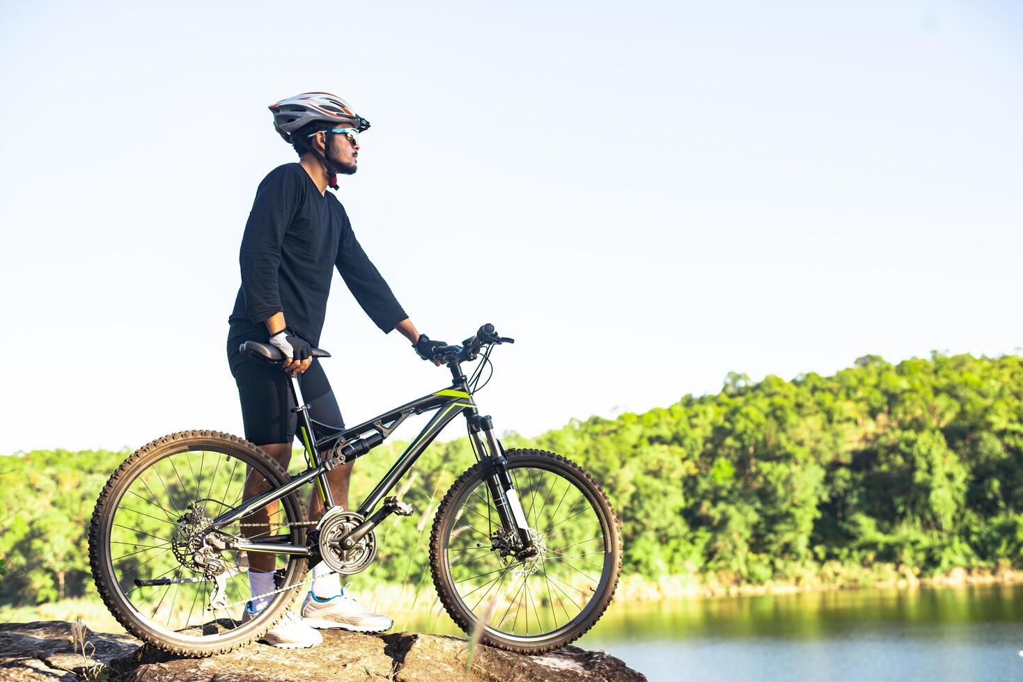 Athletes standing on the mountains with bicycle photo