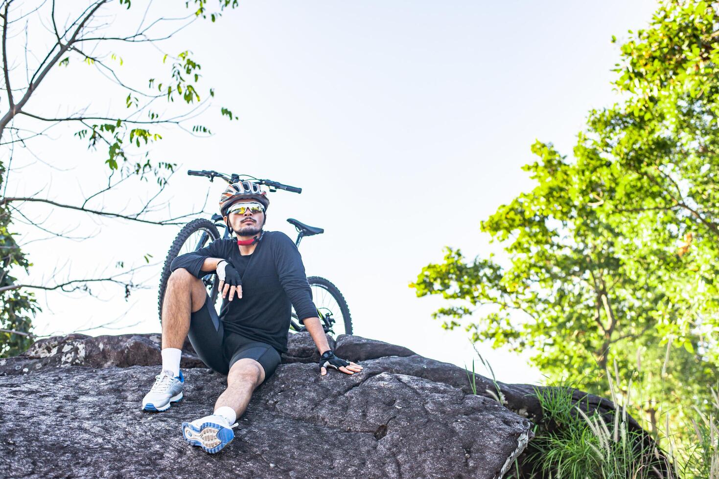 Athletes sitting on the mountain with bicycle photo
