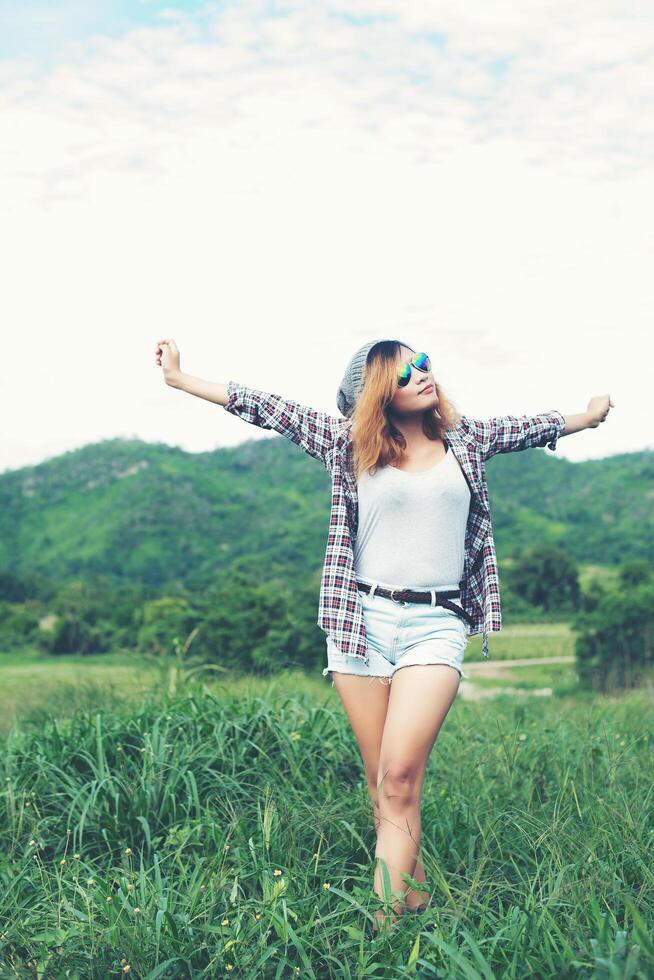 Young beautiful woman enjoying freedom and life in nature behind the mountain. photo
