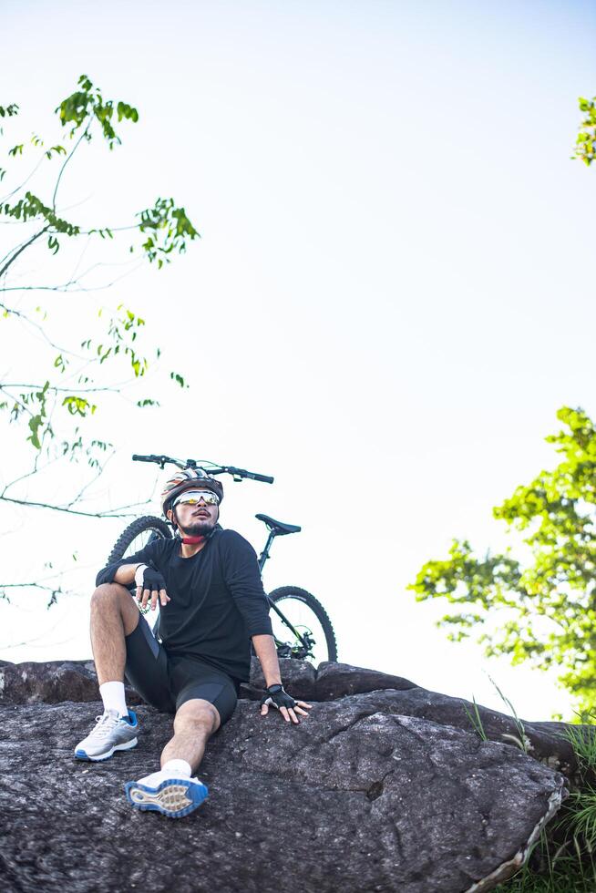 Athletes sitting on the mountain with bicycle photo