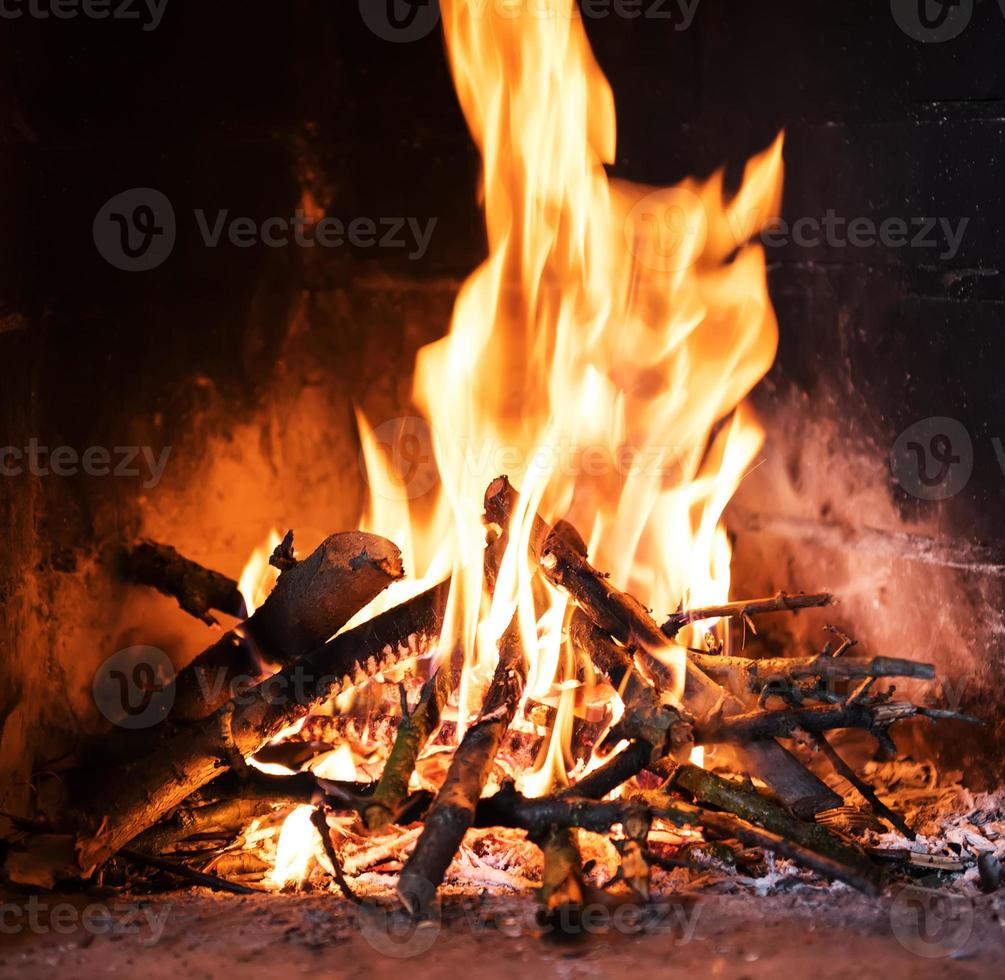 A fire burns in a fireplace photo