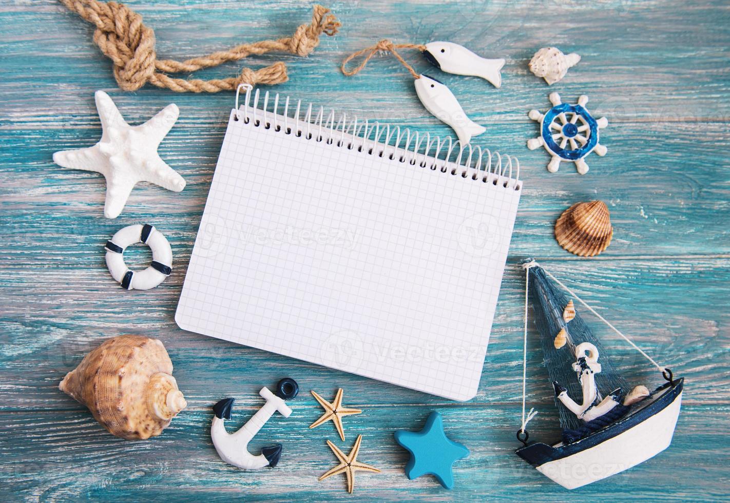Shells and notepad on wooden table photo