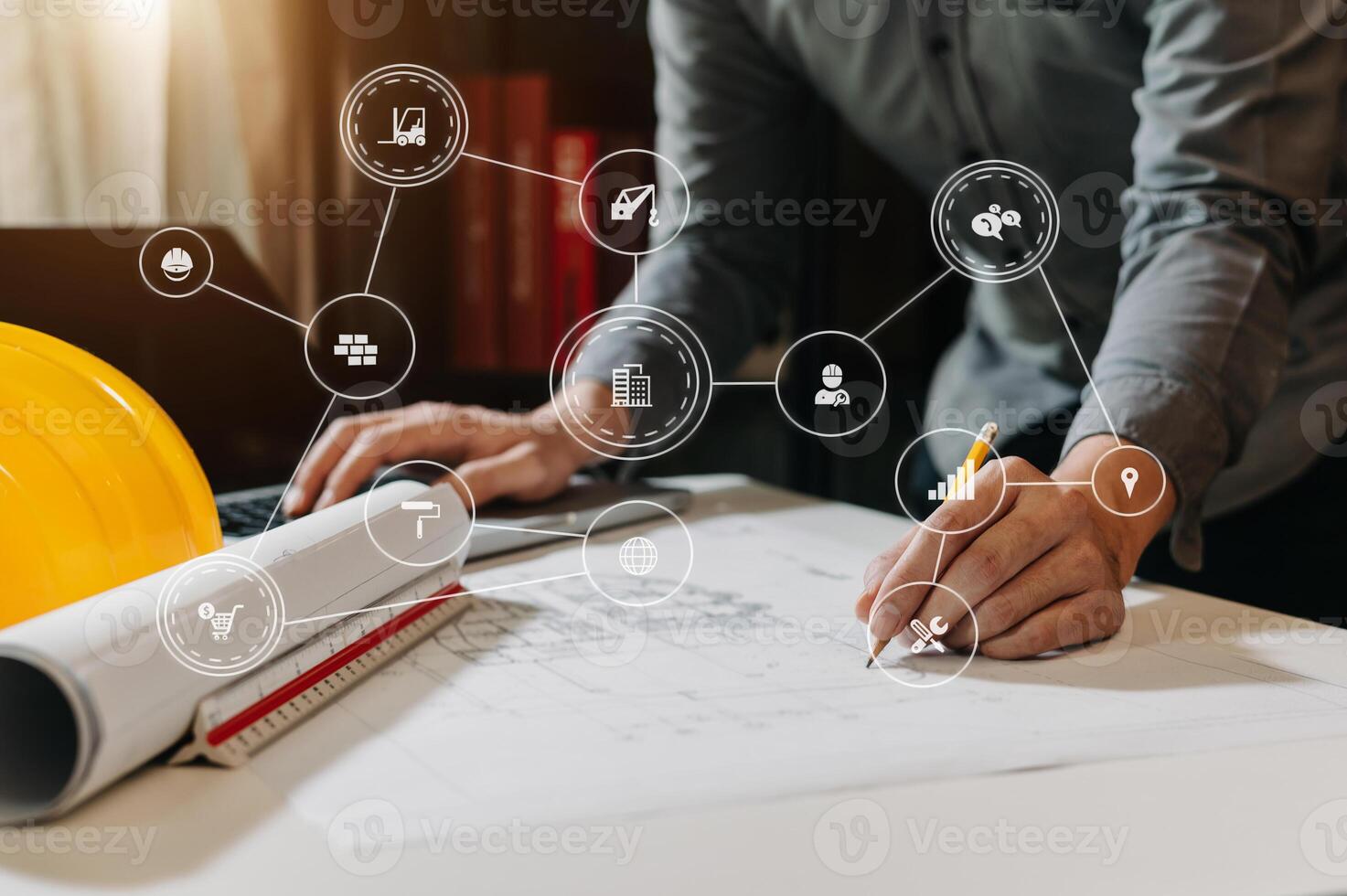 business man hand working and laptop with on on architectural project at construction site at office desk in office photo