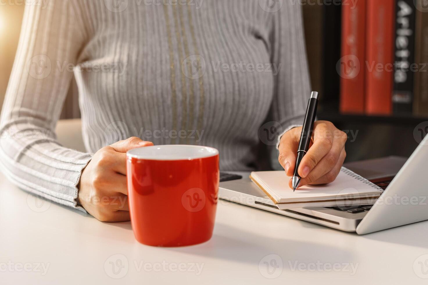 businessman hand working with new modern computer and writing on the notepad strategy diagram as concept morning light photo