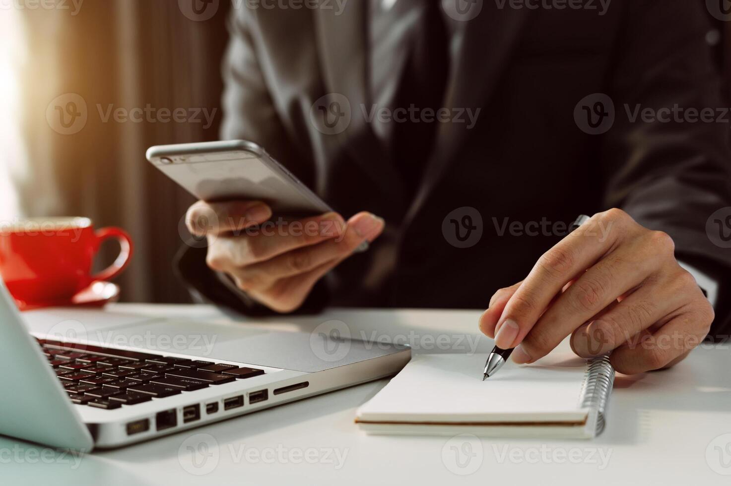 businessman hand working with new modern computer and writing on the notepad strategy diagram as concept morning light photo