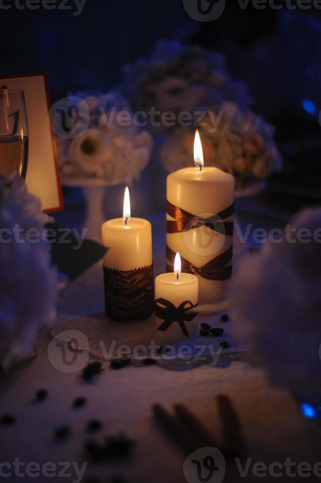 Beautiful, decorated table with flower decorations and red candles. Christmas evening or wedding party decoration. photo