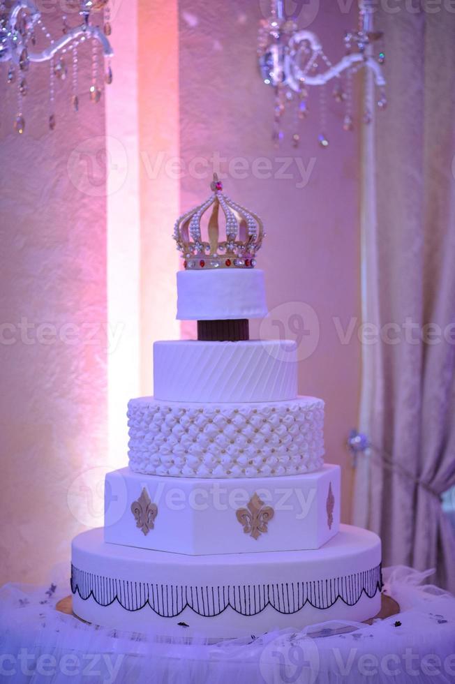 Wedding cake with luxury decorated in wedding party. Cake decorated with crown photo