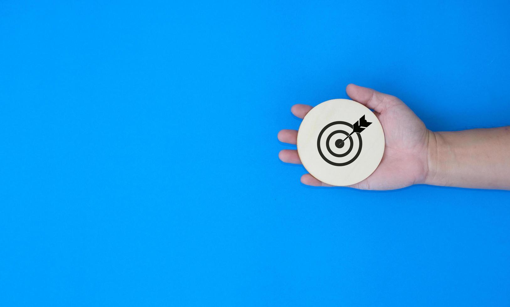 Businessman holding target of business. Dart is an opportunity and Dartboard is the target and goal. So both of that represent a challenge in business marketing as concept photo